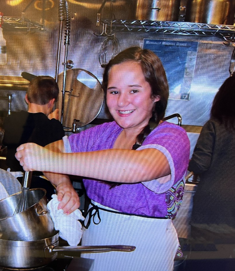 person stirring a whisk in kitchen