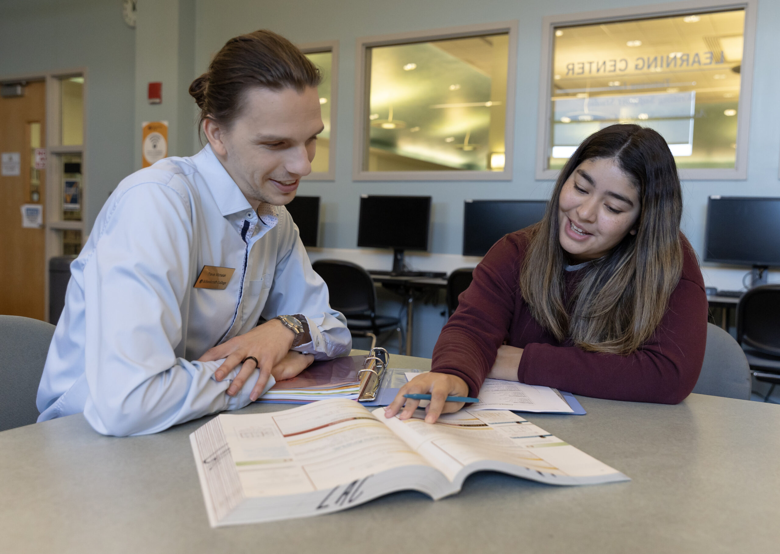 two people reading an open book