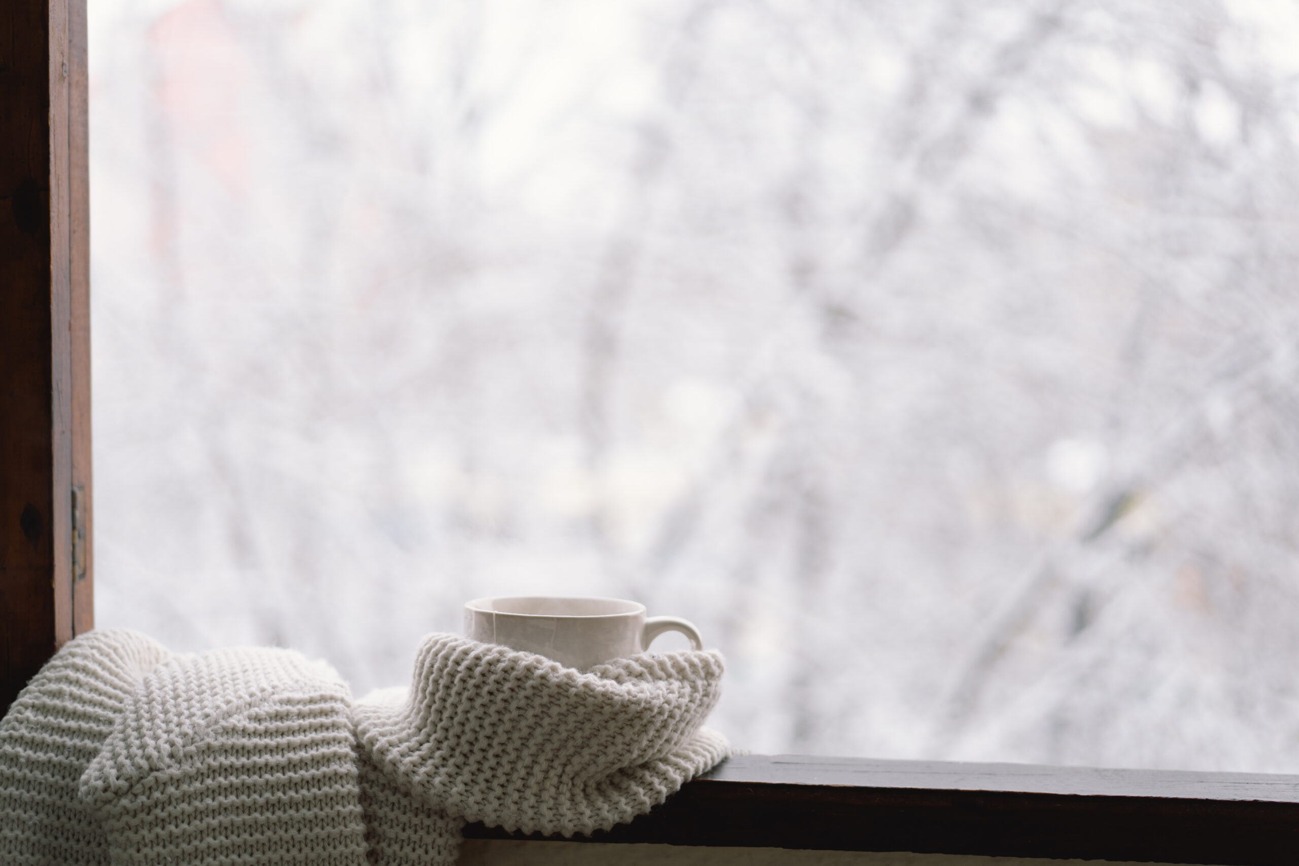 coffee cup on a winter window ledge