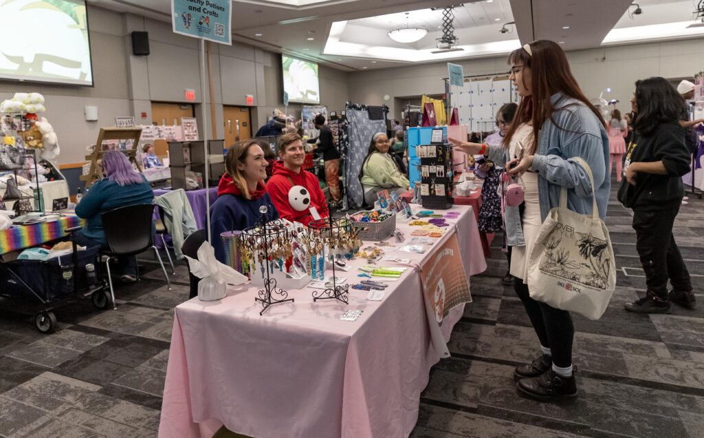 people walking around vendor tables