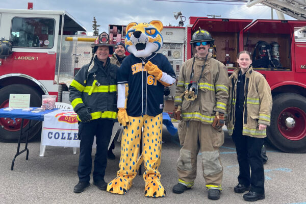 ocelot mascot with firefighters and fire truck