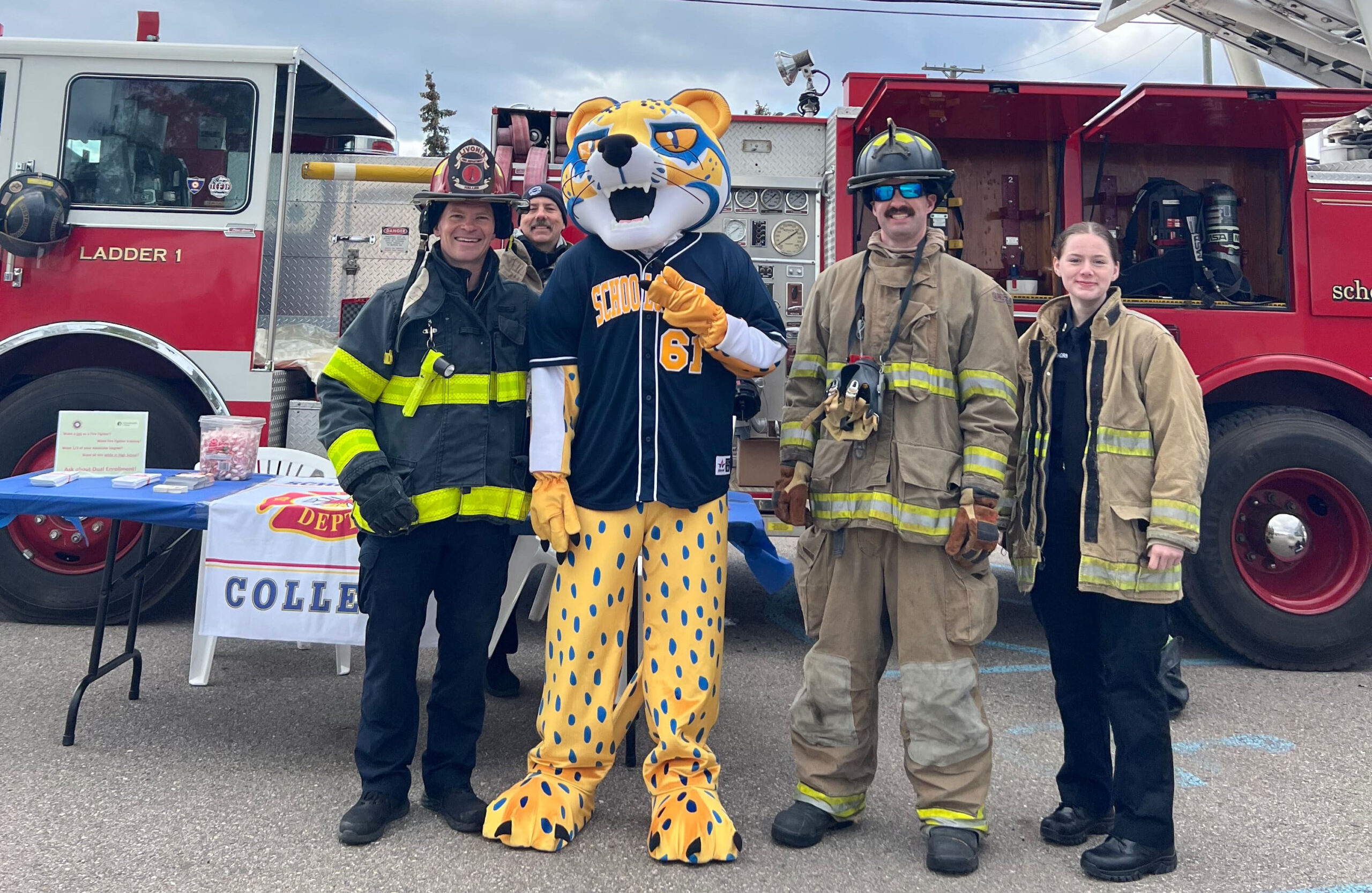 ocelot mascot with firefighters and fire truck
