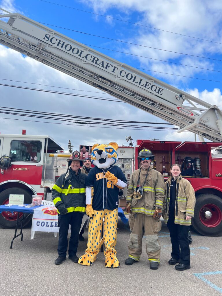 ocelot mascot with firefighters and fire truck