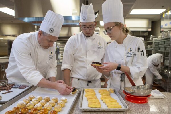 chefs glazing pastries