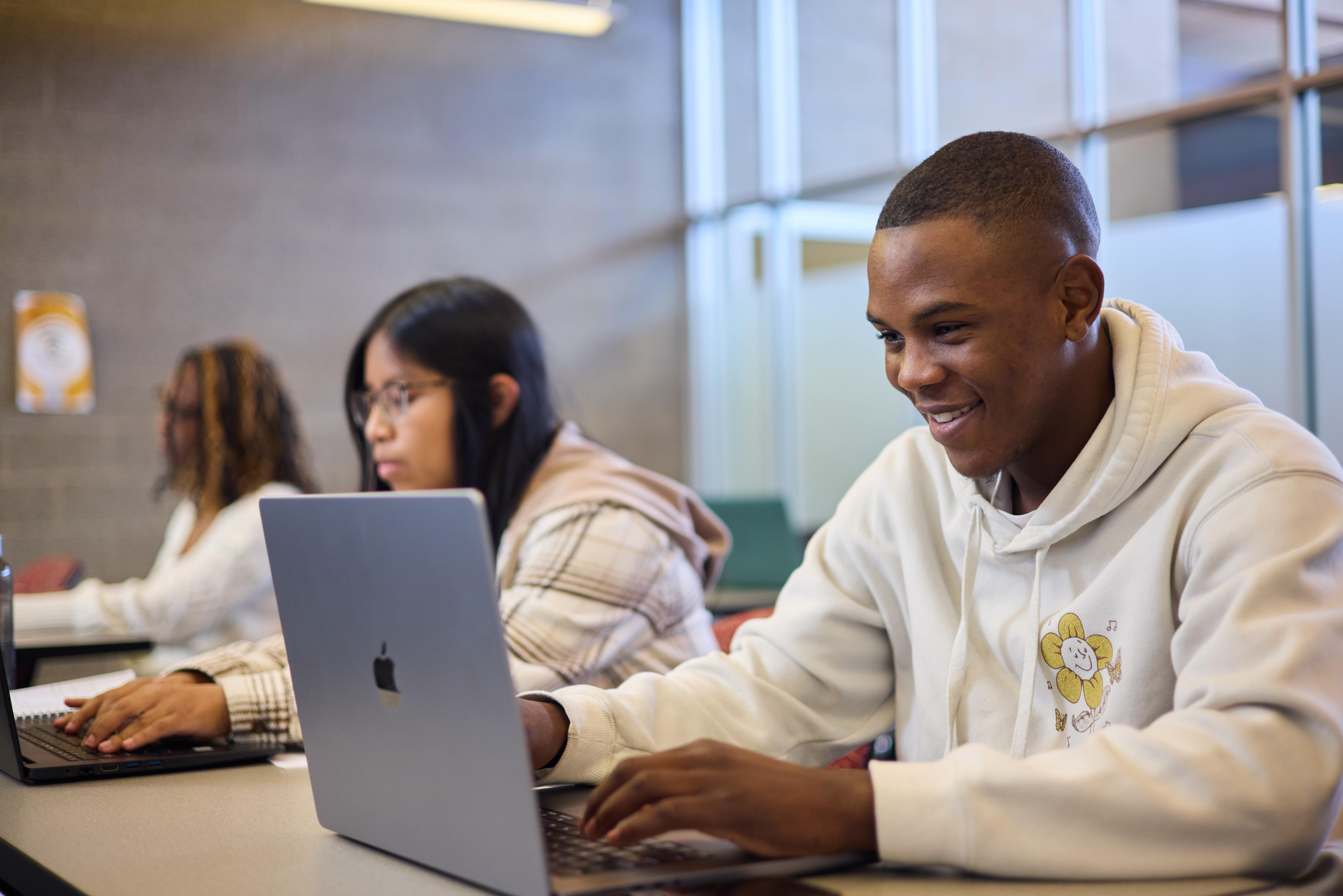 students in classroom on laptops