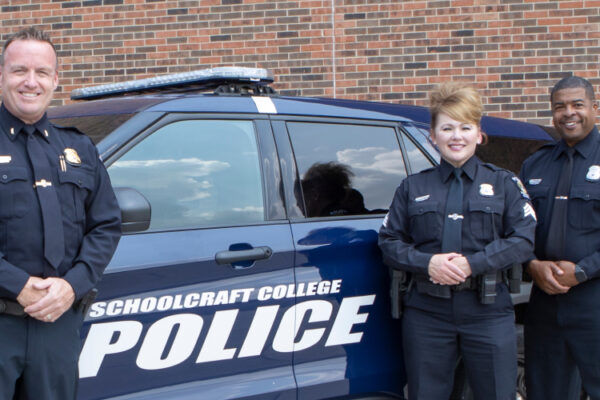 police standing by police vehicle