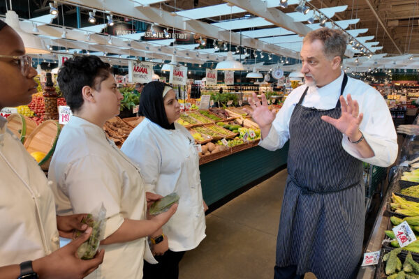 Chef Chris Misiak, CEC, speaks to students at one of Nino Salvaggio’s markets.