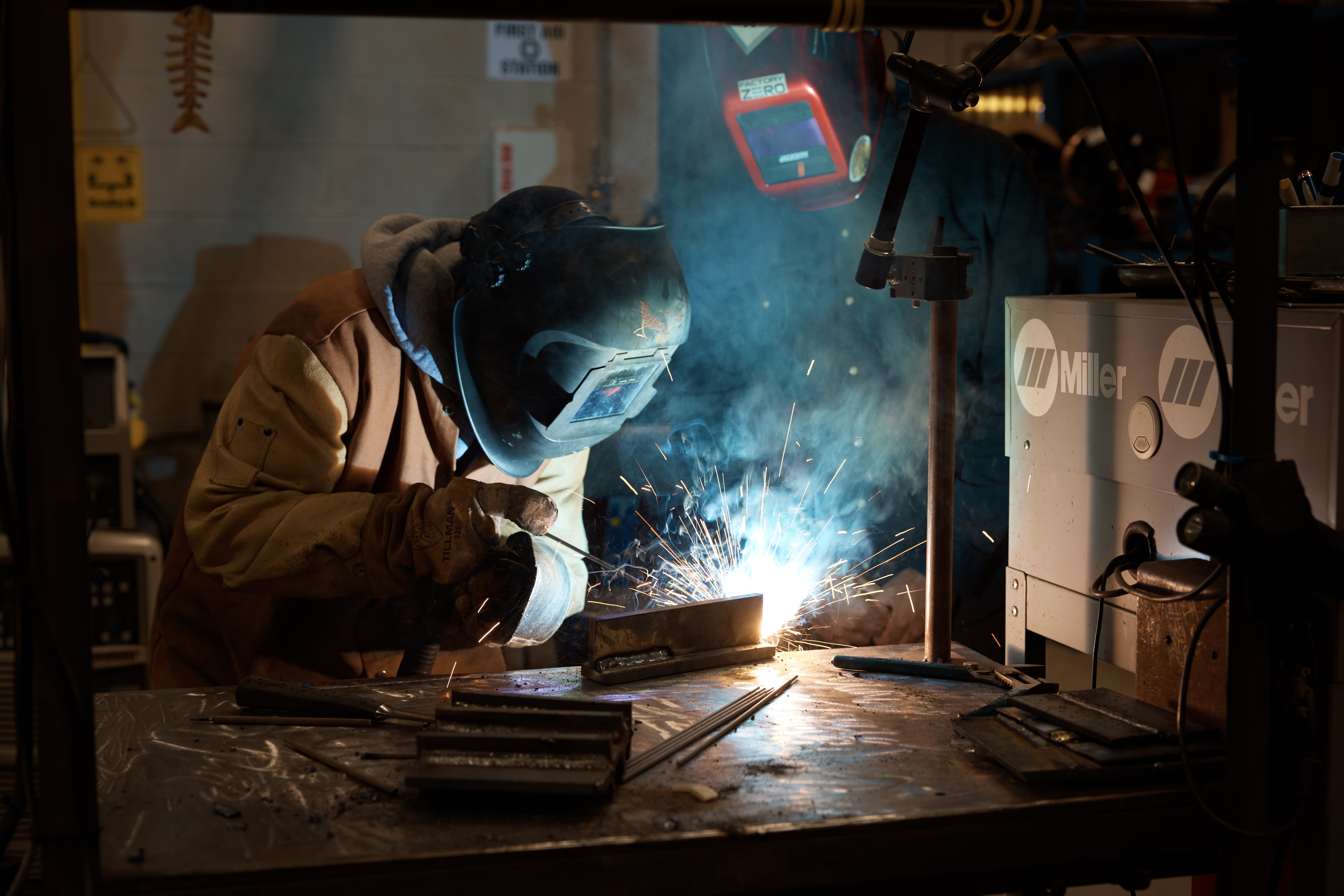 person welding, sparks flying