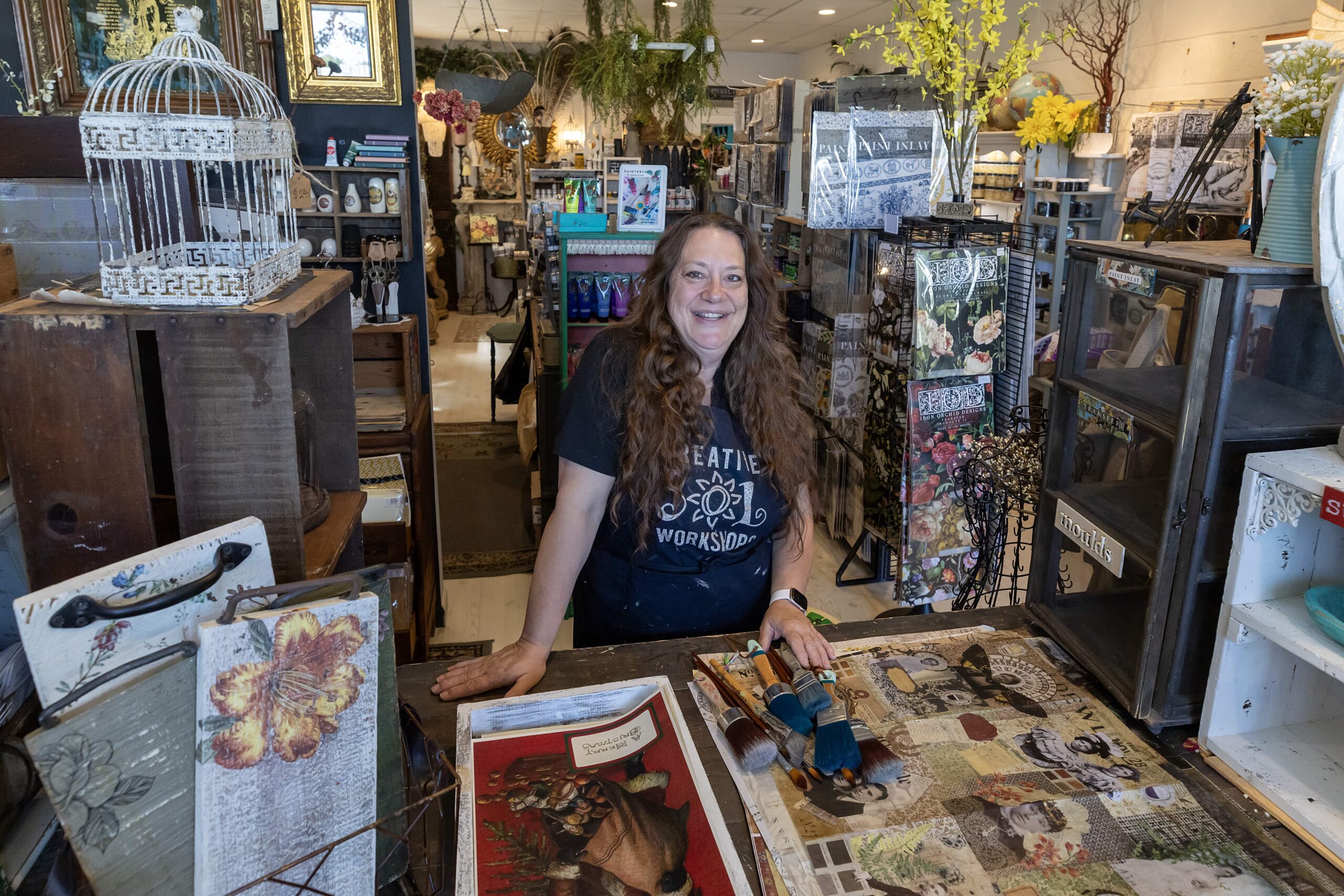 Charlotte Lawrie in her shop surrounded by art and crafts