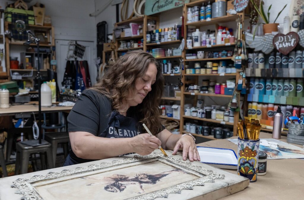 Charlotte Lawrie working on craft in maker space