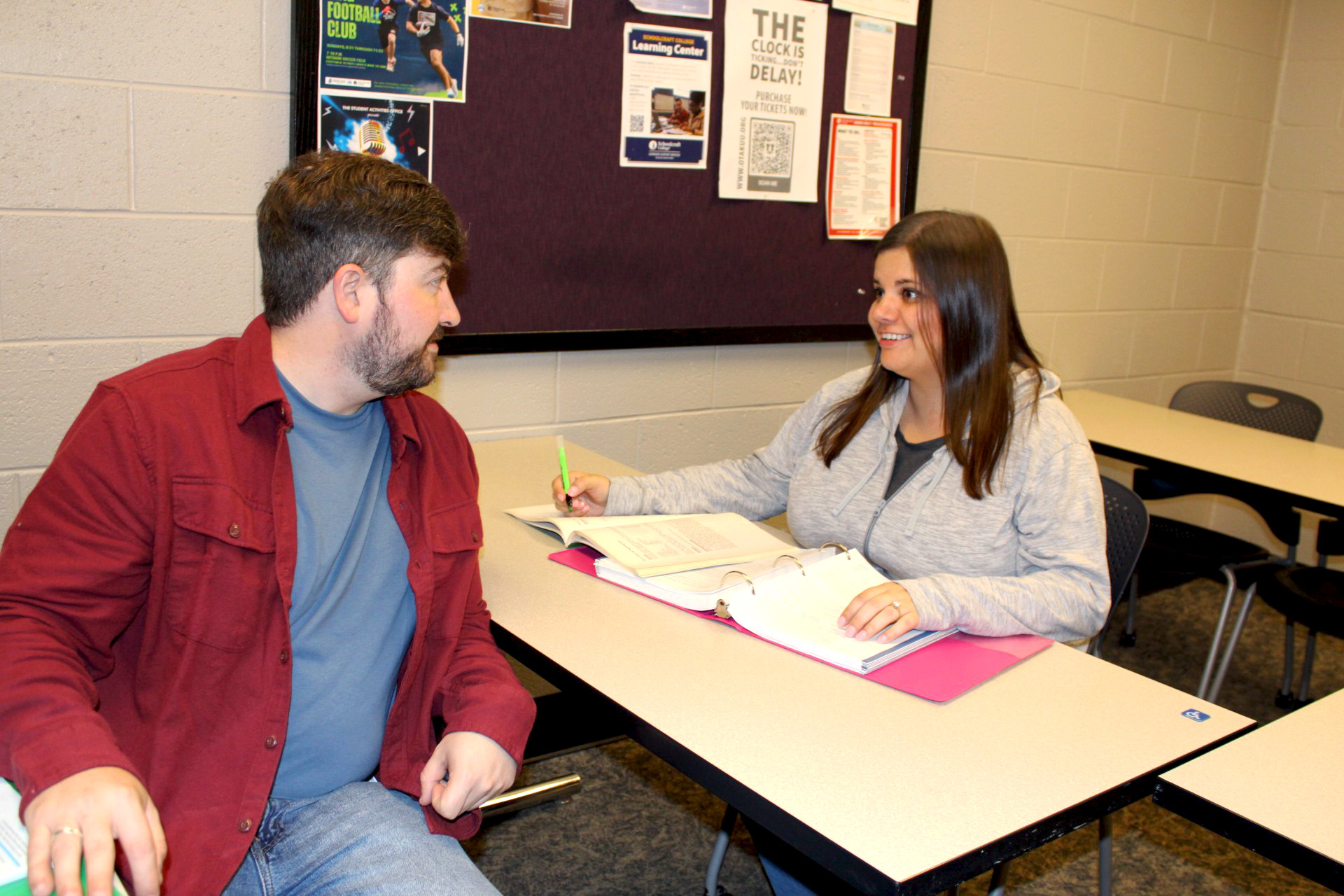 two people looking at each other in classroom setting