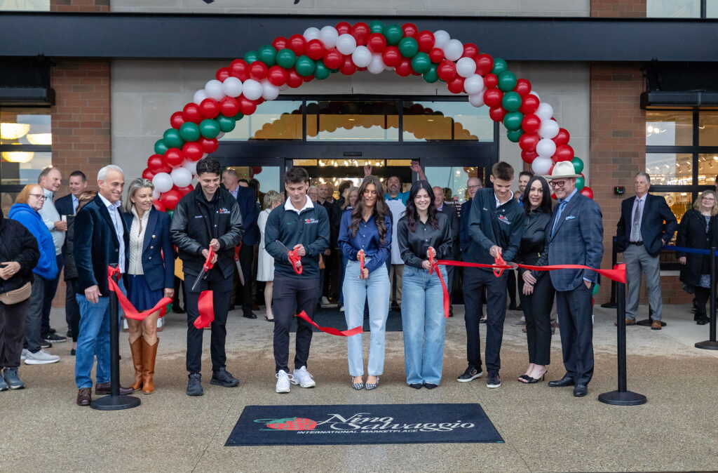 people doing ribbon cutting in front of Nino's