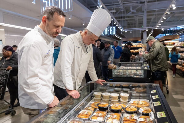 chefs looking at Ninos food display