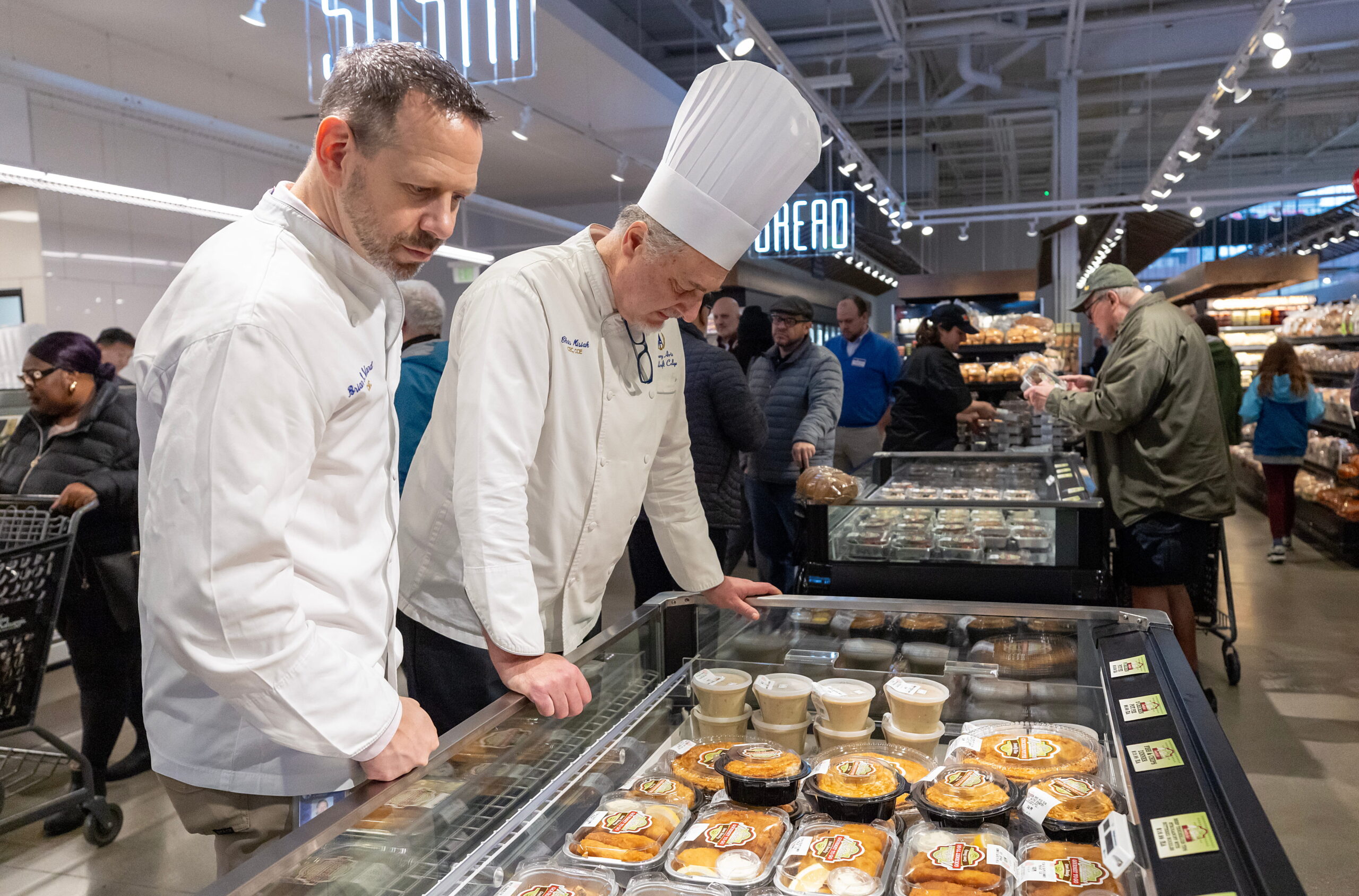 chefs looking at Ninos food display