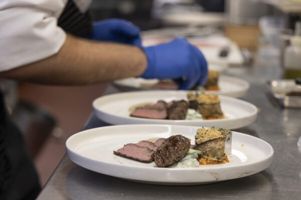 chef plating a dinner presentation on a plate