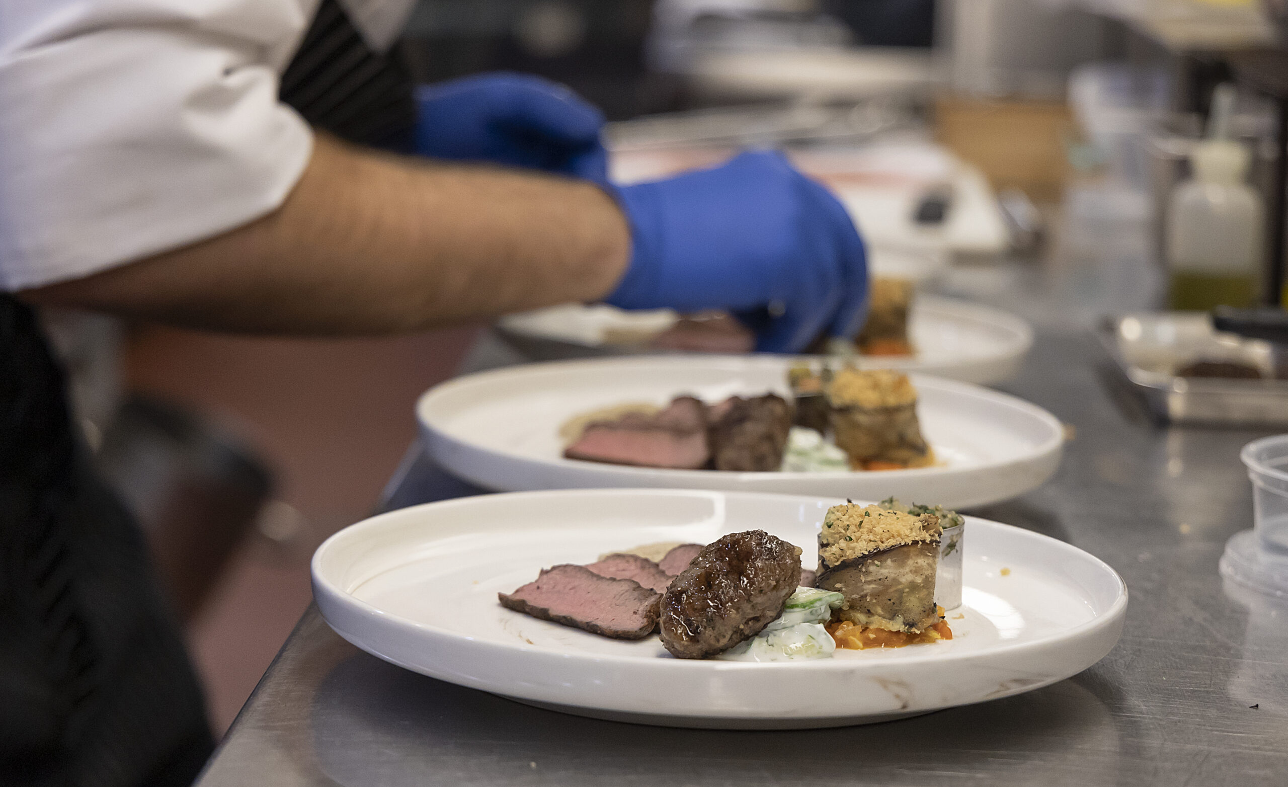 chef plating a dinner presentation on a plate