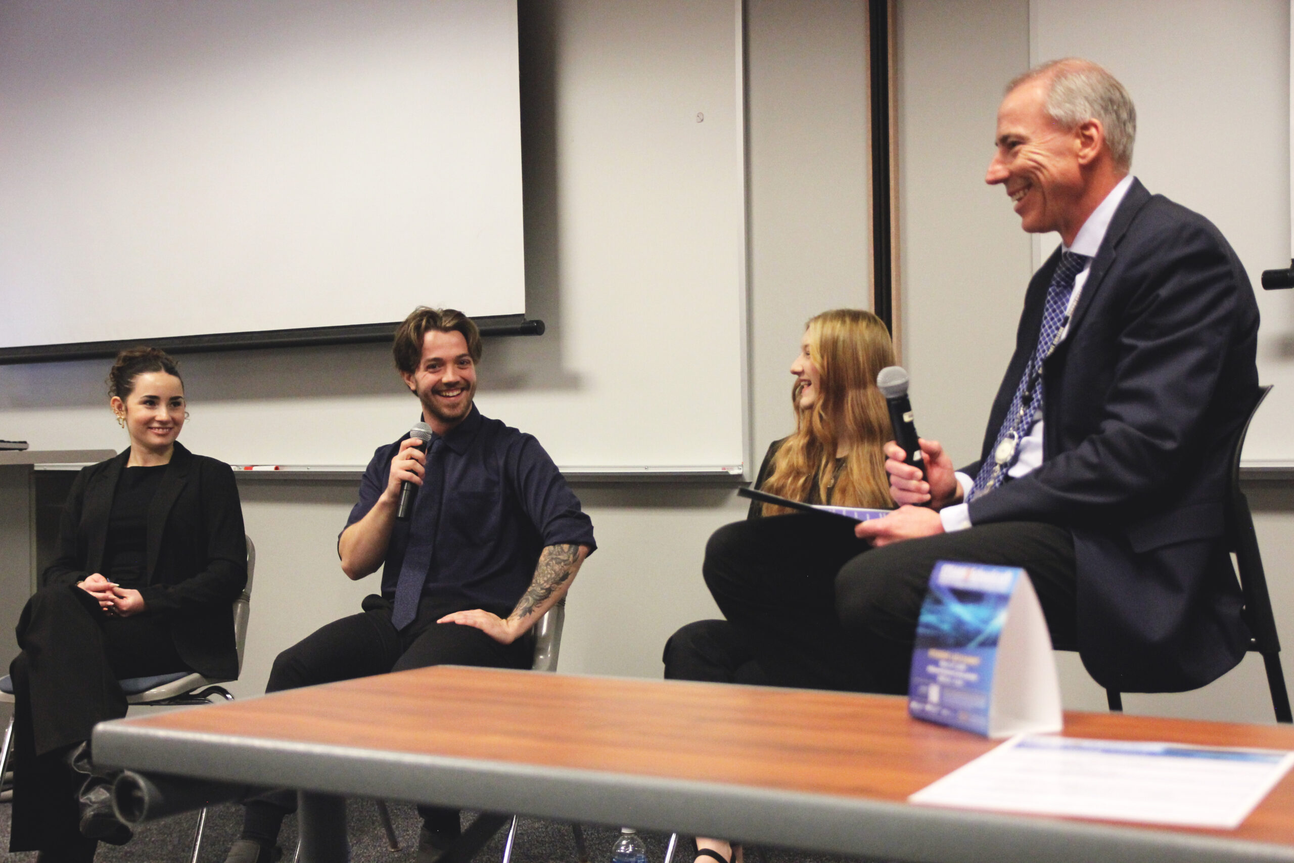 President talking with group of students