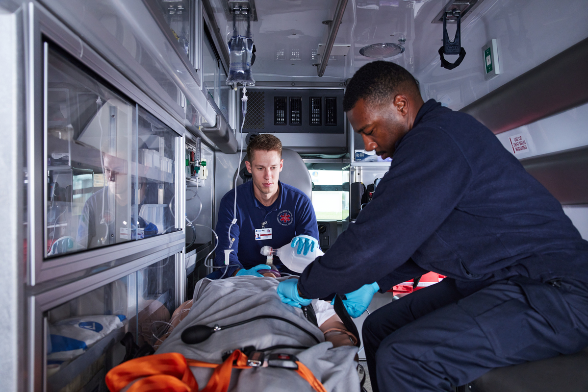 EMT students working in ambulance simulator