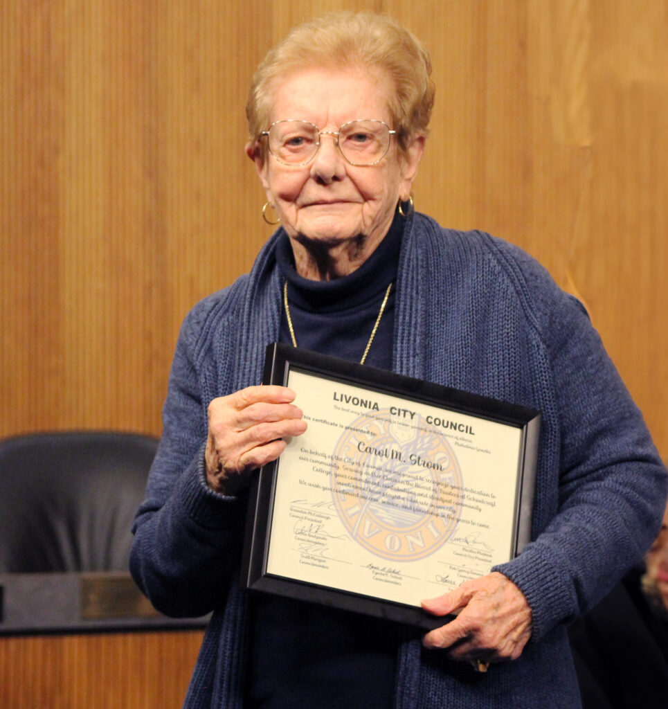 Carol Strom with a commendation from the Livonia City Council for her work