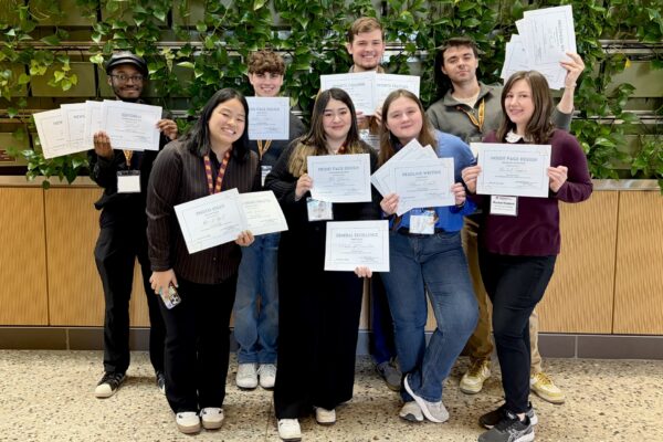 group of students holding award certificates