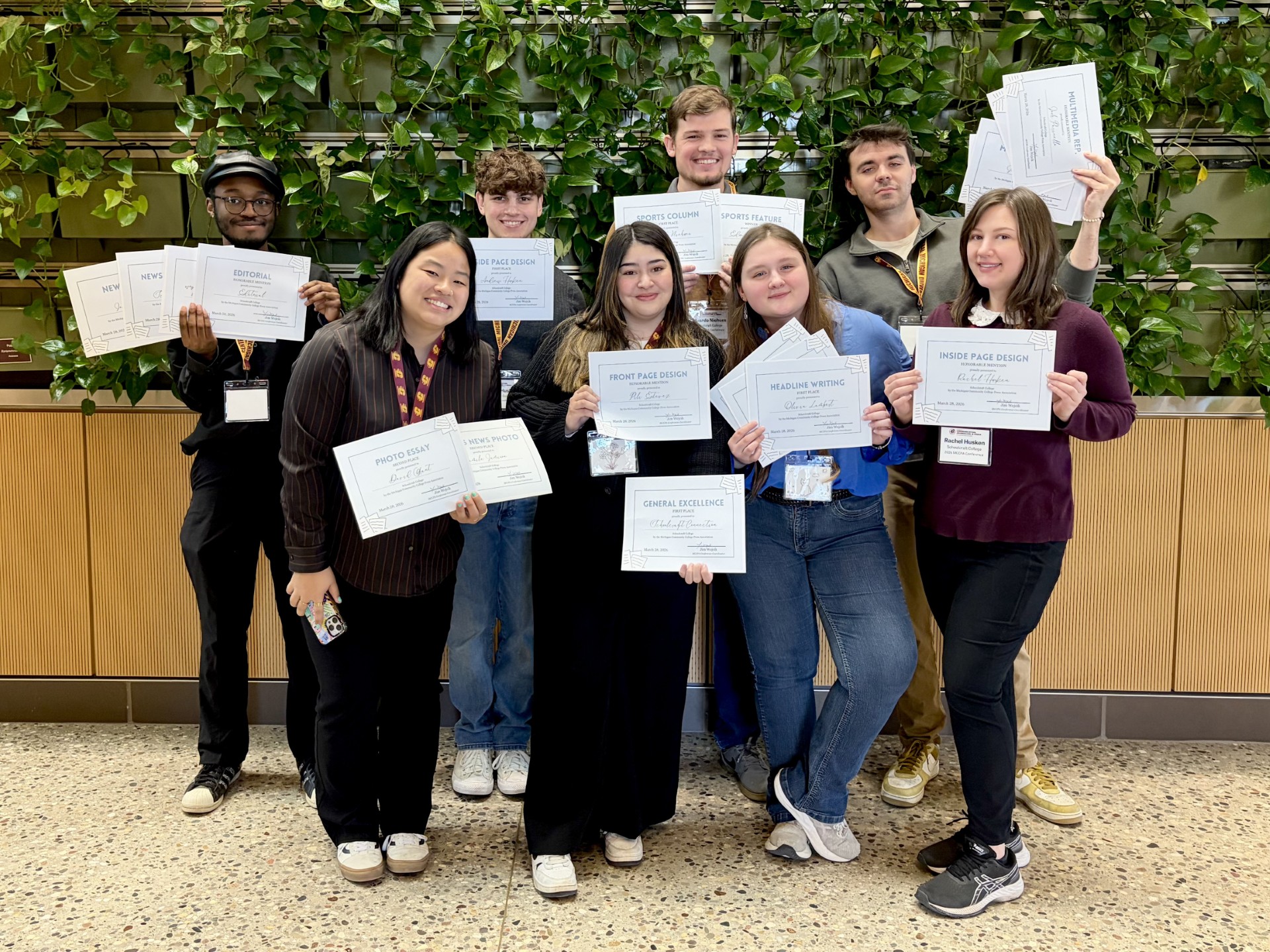 group of students holding award certificates