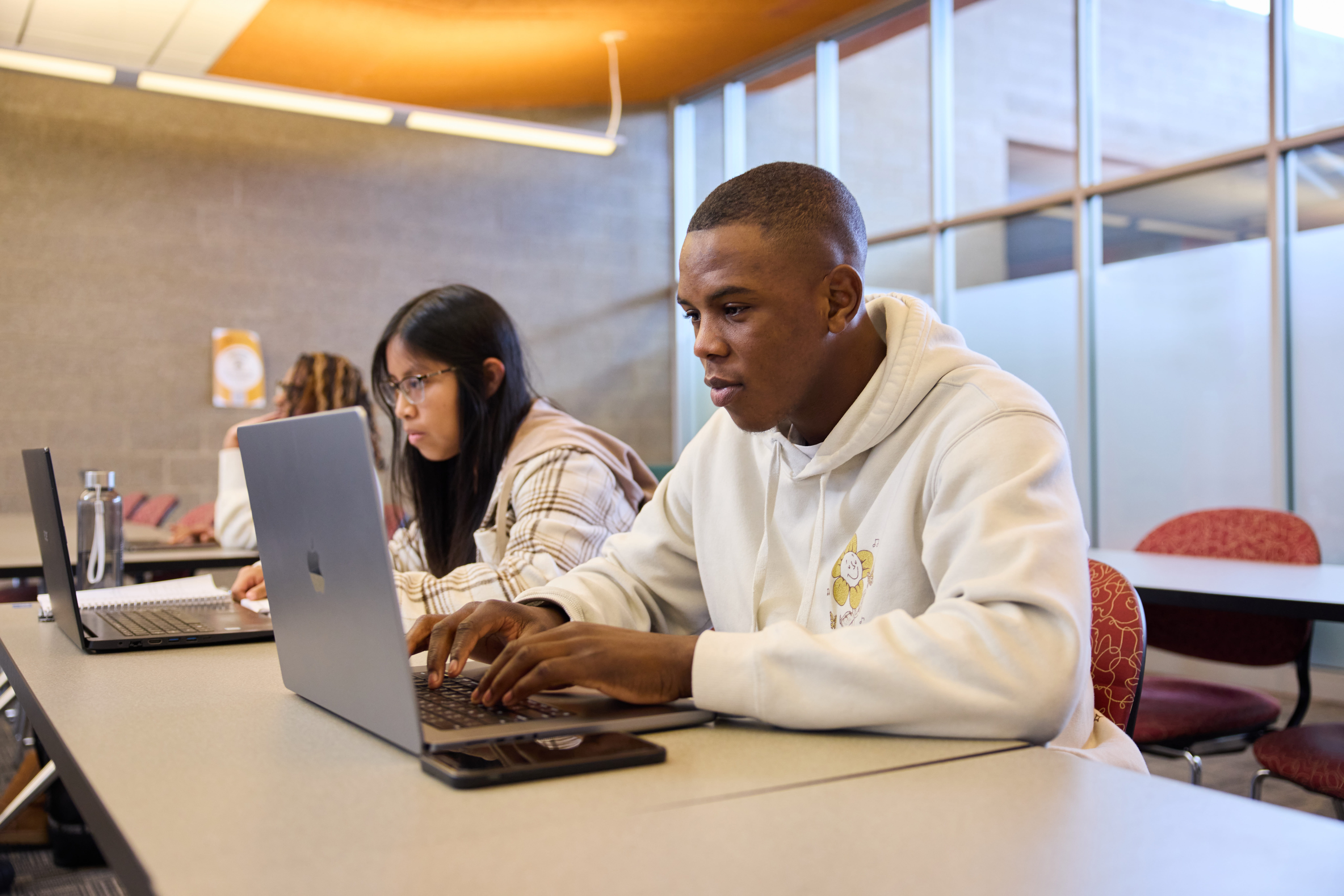 students working on their schoolwork using computers