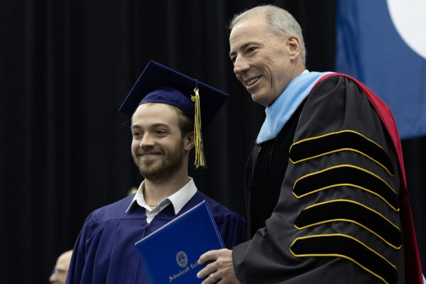 Kaleb Aethyr poses with Schoolcraft College President Dr. Glenn Cerny